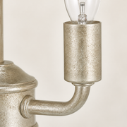 Texture | close studio view of the antique silver candle cup and curved arm texture