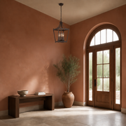 Scale | Open lantern pendant at a modest scale beside a full-height arched entry door