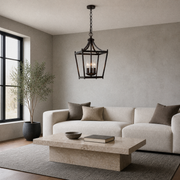 Living room | Burnished bronze open lantern pendant above a coffee table in a cool gray living room