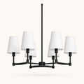 Studio front | six-light chandelier with matte black arms, white fabric drum shades, canopy, and downrod