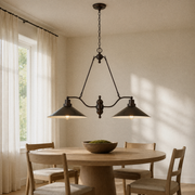In a room | bronze two-shade island pendant hung over a round oak dining table