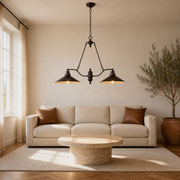 Living room | the pendant centered above a round travertine coffee table