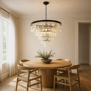In a room | matte-black crystal chandelier hanging over a round oak dining table