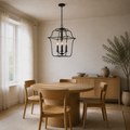 In a room | corner view of Royal Ebony lantern chandelier above round oak dining table