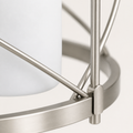 Texture | close view of brushed nickel steel X-brace, round rail, and frosted glass shade