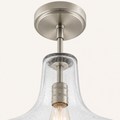 Hardware detail | brushed nickel canopy, rod joints, socket, and seeded glass neck