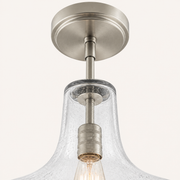 Hardware detail | brushed nickel canopy, rod joints, socket, and seeded glass neck