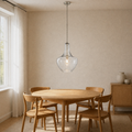 Warm ivory dining room | seeded glass schoolhouse pendant over a round oak table