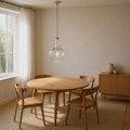 Warm ivory dining room angle | seeded glass pendant over the round oak table