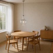 Warm ivory dining room angle | seeded glass pendant over the round oak table