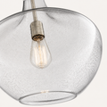 Glass detail | seeded glass bubbles, open rim, brushed nickel socket, and visible bulb