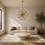 In a room | warm brass 24-light sphere chandelier lit above a living room coffee table