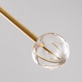Texture | macro view of the brushed brass arm and clear K9 crystal sphere