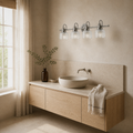 Angle | three-quarter view in a warm limewash powder room of an antique-nickel 4-light vanity