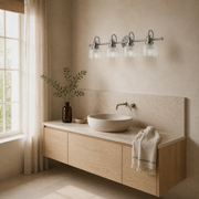 Angle | three-quarter view in a warm limewash powder room of an antique-nickel 4-light vanity