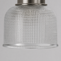 Texture | extreme close-up of a clear double-prismatic glass cylinder shade and antique-nickel collar