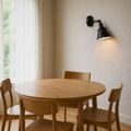 Dining room | second angle of the matte black cone wall sconce above the oak dining table