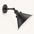 Studio front | matte black wall sconce with circular backplate, arm, swivel elbow, and cone shade