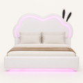 Front | Straight-on studio view of the white bed with its cloud-shaped back, illuminated outline, and rounded feet.