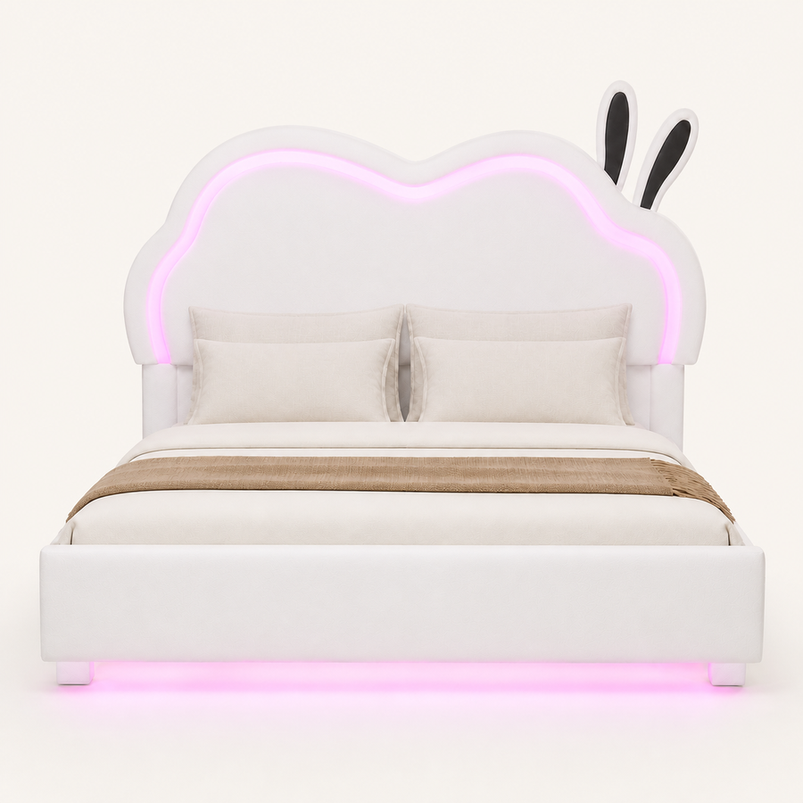 Front | Straight-on studio view of the white bed with its cloud-shaped back, illuminated outline, and rounded feet.