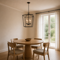 Scale | the chandelier hanging in the dining room beside a full-height window for size reference