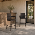 Scale | two dark brown woven wicker bar stools beside a full-height glass doorway at an outdoor bar