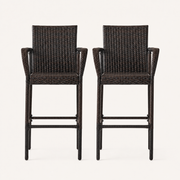 Front | front studio view of two dark brown woven wicker bar stools on a warm white background