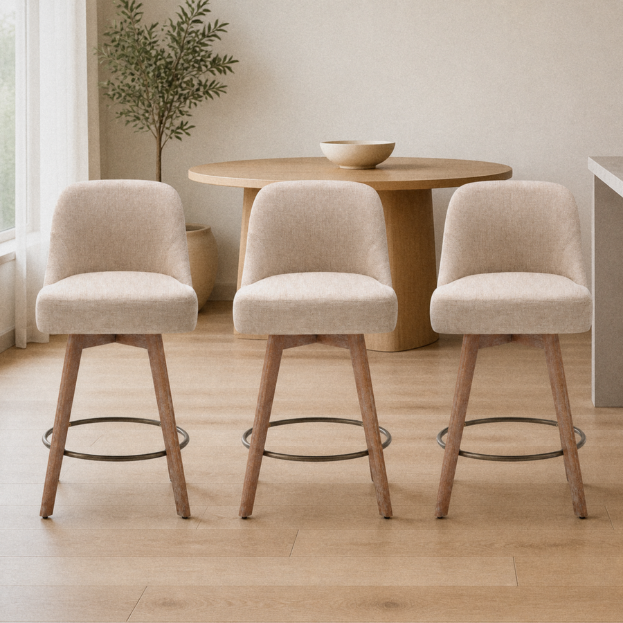 In a room | all three matching stools at a warm oak dining room's island edge, soft morning sidelight from the left