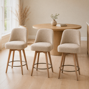 In a room | all three matching stools at a bright flax dining room's island edge, soft midday light from the left