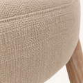 Closer | beige woven fabric weave close against the whitewashed wood leg