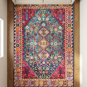 Pennine rug | seen from above on a wood floor, the pattern filling the frame below a sofa
