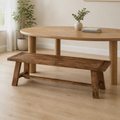In a room | the same bench along a bright flax dining room's round table, soft midday light from the left