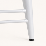 Detail | the X-brace, footrest rails and floor glide where the base meets the floor