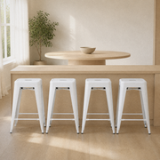 In a room | all four matching stools at a warm oak dining room's island edge, soft morning sidelight from the left