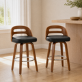 In a room | both matching swivel bar stools at a flax dining room's kitchen island edge, bright midday light from the left