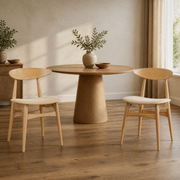 In a room | both matching natural rubberwood side chairs with beige fabric seats at a table in a warm plaster dining room, low afternoon light