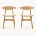 Front | both natural rubberwood side chairs with beige fabric seats centered on paper, curved crescent backs visible