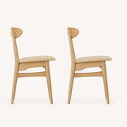 Side | profile view of both chairs showing the tapered leg splay and the crescent back depth