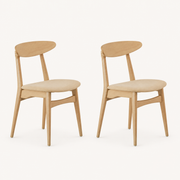 Studio | both chairs at a true three-quarter angle, the crescent back curve and seat both reading