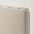 Piped edge | Close view of the piped beige headboard corner