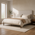 Room 1 angle | Three-quarter view of the beige piped bed in the bright limewash bedroom