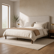 Room 1 angle | Three-quarter view of the beige piped bed in the bright limewash bedroom