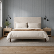 Room 3 | Straight-on view of the beige piped bed in a blue-gray paneled bedroom with ash nightstands