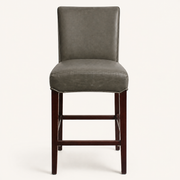 Front | vintage gray faux-leather counter stool centered on paper, four dark cherry-mahogany wood legs and footrest