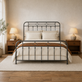 Room hero | Straight-on bedroom with the dark metal bed centered between wood nightstands and a light rug
