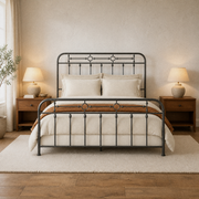 Room hero | Straight-on bedroom with the dark metal bed centered between wood nightstands and a light rug