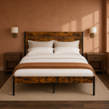 Clay room | Front view in a warm clay-toned room with brass sconces, dark nightstands, and the bed frame
