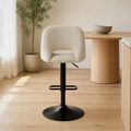 In a room | the stool at a warm oak dining room's kitchen island edge, soft morning sidelight from the left