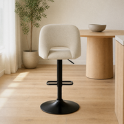 In a room | the stool at a warm oak dining room's kitchen island edge, soft morning sidelight from the left