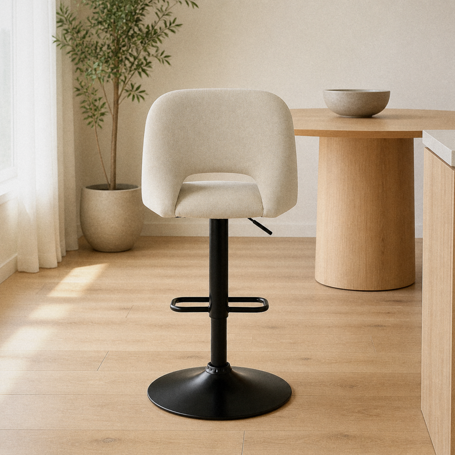 In a room | the stool at a warm oak dining room's kitchen island edge, soft morning sidelight from the left